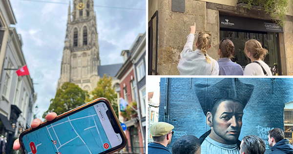 Twee spelers met een tablet en plattegrond tijdens een stadsspel, een actieve manier om een stad te ontdekken.